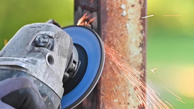 Grinding Metal with Sander at construction site .