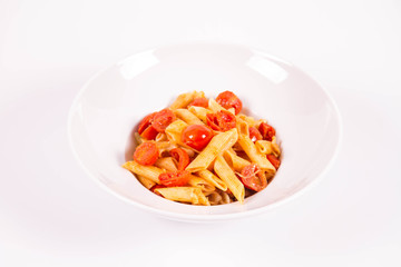 Penne with tomatoes, garlic and mozzarella on a white background