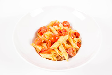Penne with tomatoes, garlic and mozzarella on a white background