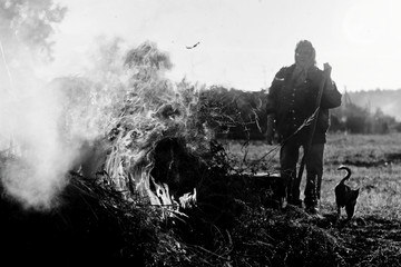 Old woman works in garden. Countryside life. Black white photo