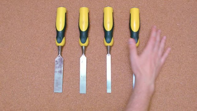 Wood Working Tools being removed from a cork surface