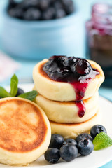 Cottage cheese fritters with blueberry jam closeup view. Tasty sweet breakfast food