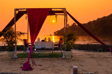 Fototapeta premium gazebo for relaxing on the beach at sunset, a romantic dinner in the privacy