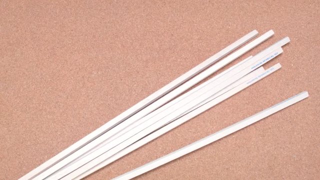 Set of wooden sticks being tossed over a cork surface