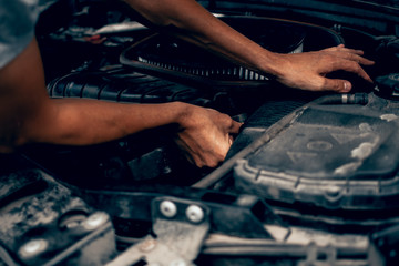 Car repair by a man in a workshop service station