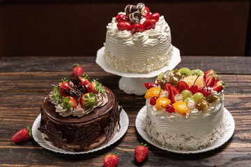 Various cakes on wooden background or table. Assortment of cakes for celebrations.