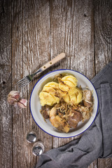 Fried liver with onion and apple, served with boiled potatoes and pickled cucumber.