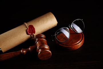 Last will and testament and glasses with wooden gavel.