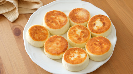 Cottage cheese fritters on plate. Russian and Ukrainian cuisine syrniki