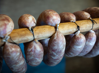 Homemade sausage, several rings, hang on a stick. Soft focus.