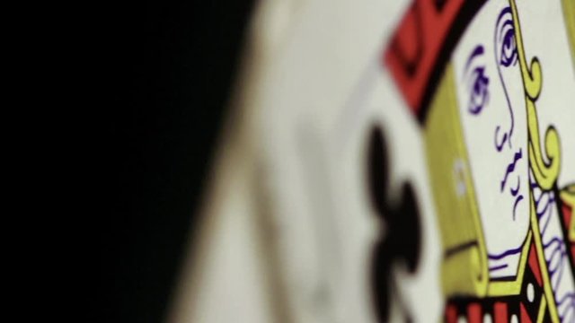 macro of a jack of clubs rotating into focus 