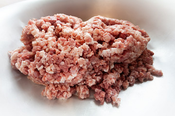 Minced pork meat in a large aluminum plate