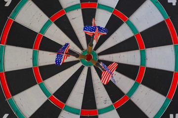 Three darts with US  flags at the center of the target. Success hitting target,  goal achievement concept. 100% hit. 