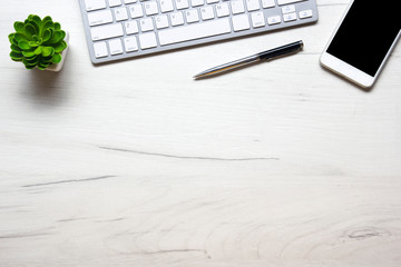 White desk office with laptop, smartphone and other work supplies with cup of coffee. Top view with copy space for input the text. Designer workspace on desk table essential elements on flat lay