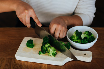 woman hands cutting vegetables on table