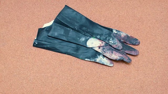 Safety Gloves being set over a cork surface