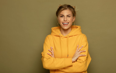 Portrait of a pretty smiling woman posing isolated on a color background.