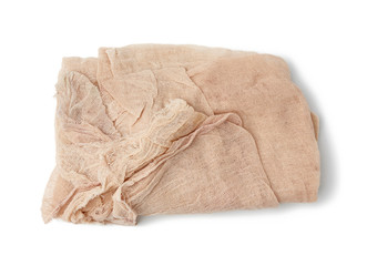 folded cotton beige gauze fabric isolated on white background