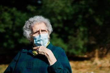 Mature woman with face mask thinking