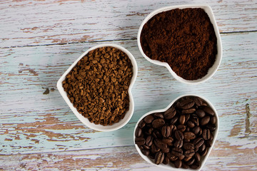 Coffee beans, ground coffee and freeze-dried coffee. Soft focus.