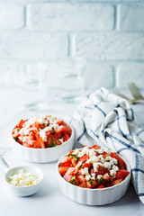 Feta cheese tomato salad in a white bowl