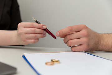Prenuptial agreement concept. Man and woman signing notary document together