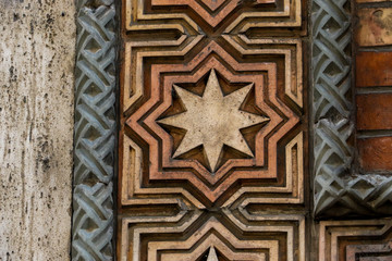 Old eight pointed star tile on a wall