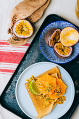 Crepes Or Thin Pancakes With Delicious passion fruit and lime. Summer tropical concept.