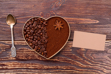 Fototapeta na wymiar Coffee breakfast concept. Teaspoon with coffee heart and blank paper for copyspace.