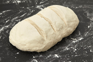 Bread dough on the table before backing. Close up.