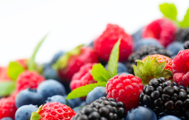 Berries. Various colorful berries background. Mint leaves, Strawberry, Raspberry, Blackberry, Blueberry close-up backdrop, isolated on white. Border label design.Bio Fruits, Healthy eating, diet