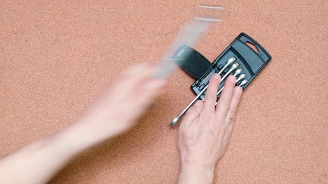 Set of wrenches being set over a cork surface