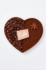 Heart-shaped decorative heart made of coffee grains. Isolated on white background.