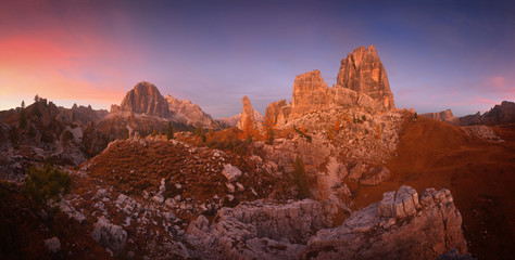 Pink sunset with view of Tofana di Rozes and Cinque Torri. Enchanting autumn sunset in the Dolomites. Autumn landscape with views Five Pillars in Dolomites mountains. Dolomites. Italy. Europe.