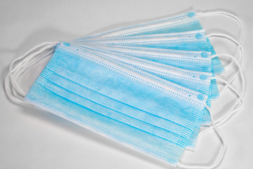 Medical sterile disposable masks. Blue medical masks on a white background.