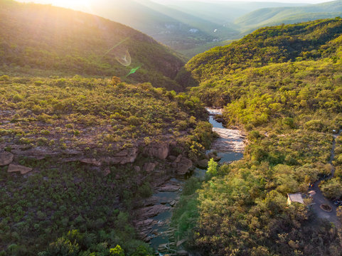 Aeirial of Rio Preto Canyon after Cachoeira do Riachinho Waterfall and environing caatinga vegetation landscape at Vale do Capao, Bahia, Brazil. Drone moving forward