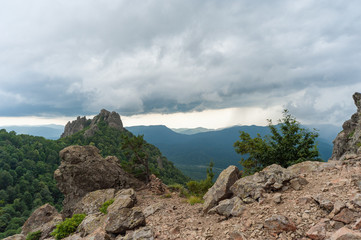 view of the valley from the height of the mountain range in a cloudy sky