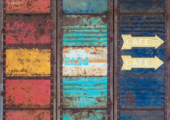 Old iron gate made of barrels. Closed sheet metal doors.
