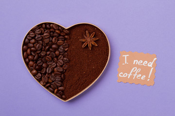 I need coffee concept. Coffee heart as an art. Coffee beans and instant coffee powder on purple background.