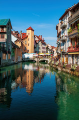 Colorful medieval houses reflected in water of the canal in Annecy, France