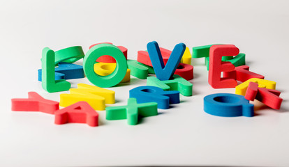 The word love consists of letters of different colors on a white background.