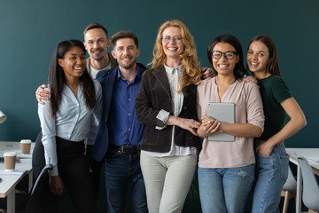 Portrait of standing in row smiling team embracing looking at camera. Happy diverse corporate staff, hugging specialists, company representatives, bank workers photo shoot, HR agency recruitments.