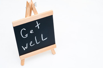 Get well writing on a slate. Slate on white background. Get well concept. Positive background. Recovery concept. Healing concept. 