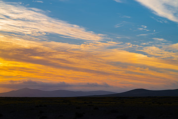 sunset colors reflected in the clouds, in the atacama desert