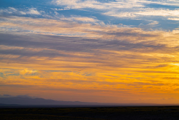 Naklejka na ściany i meble sunset colors reflected in the clouds, in the atacama desert