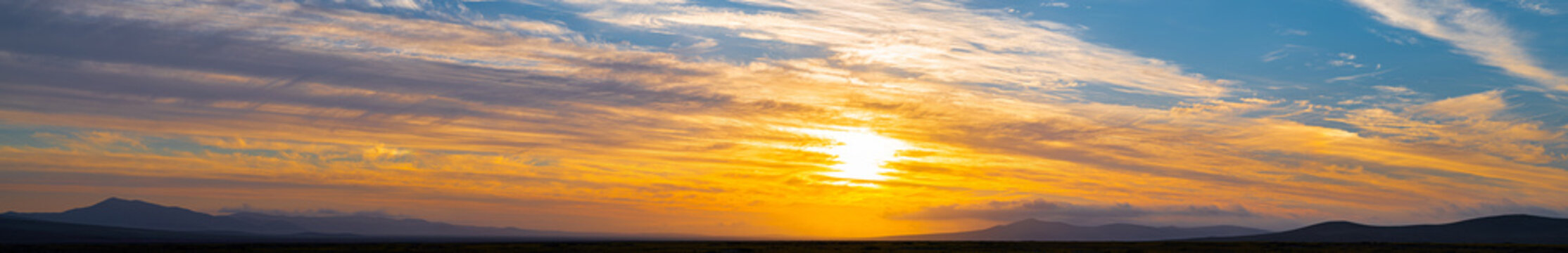 panoramic sunset colors reflected in the clouds, in the atacama desert