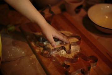 a little boy helps bake cookies
