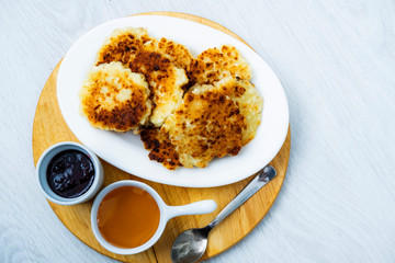 Fried cottage cheese cottage cheese with jam and honey top view.