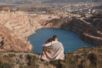 Fototapeta na wymiar a couple in love admires the view of a mountain lake