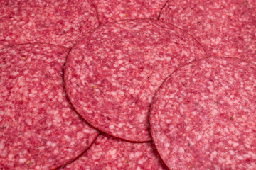 Tasty salami slices background.